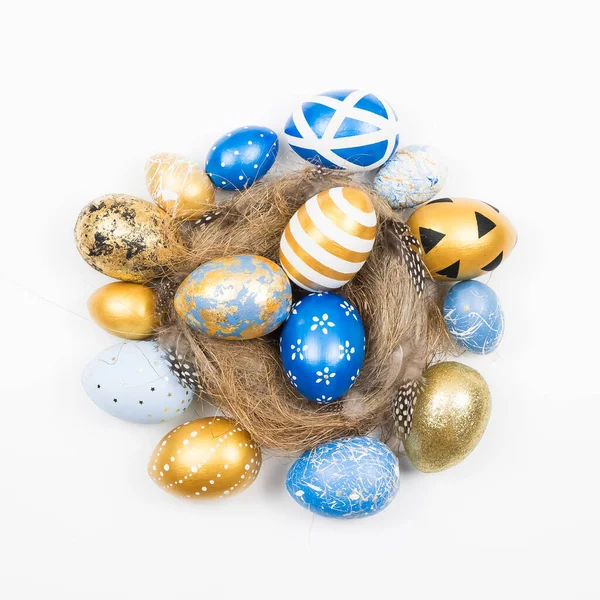 Frame of Easter golden decorated eggs in nest isolated on white background for web banner. Minimal easter concept. Happy Easter card with copy space for text. Top view, flatlay.