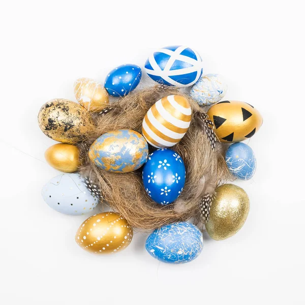 Frame of Easter golden decorated eggs in nest isolated on white background for web banner. Minimal easter concept. Happy Easter card with copy space for text. Top view, flatlay. Stock Photo