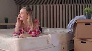 Kadın arkadaş cep telefonundan arayarak yeni daire yatak/açma kutuları procrastinates