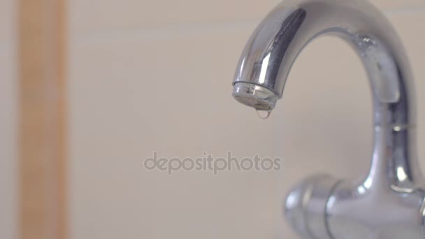 Dripping bathroom faucet spout. View from front straight on at low angle — Stock Video