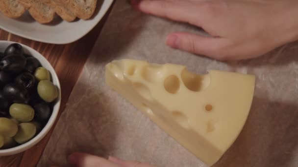 Piece of cheese, bread olive and greens — Stock Video