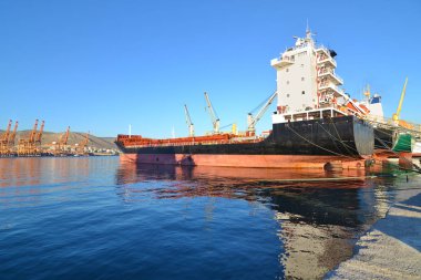 boats and tanker at the industrial area of Drapetsona Greece clipart