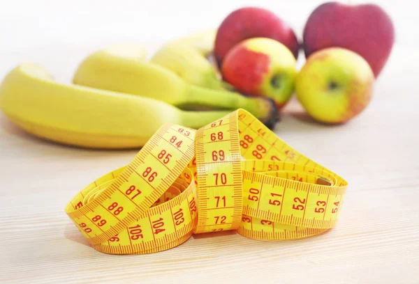 Mele e banane con metro a nastro - concetto di dieta — Foto Stock