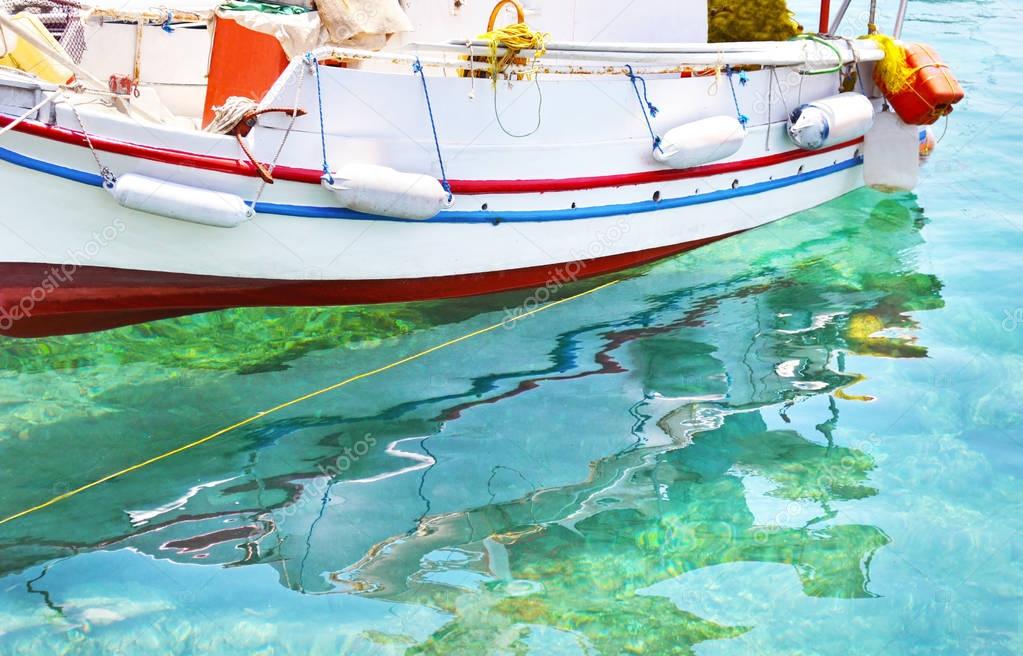 fishing boat reflected on sea Aegina island Greece