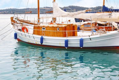 boat reflection on sea at Porto Heli Argolis Greece clipart