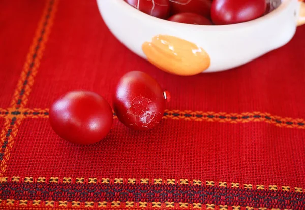 close up of red Easter eggs on the table - cracked eggs Orthodox greek tradition