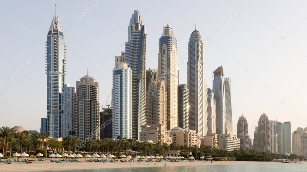 Dubai Marina tall skyscrapers in a bright warm evening