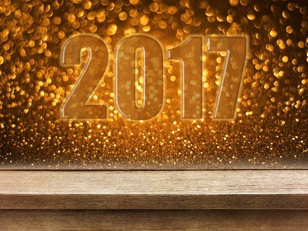 Frohes neues Jahr 2017 auf Holztisch mit goldenem Glitzerbokeh zurück — Stockfoto