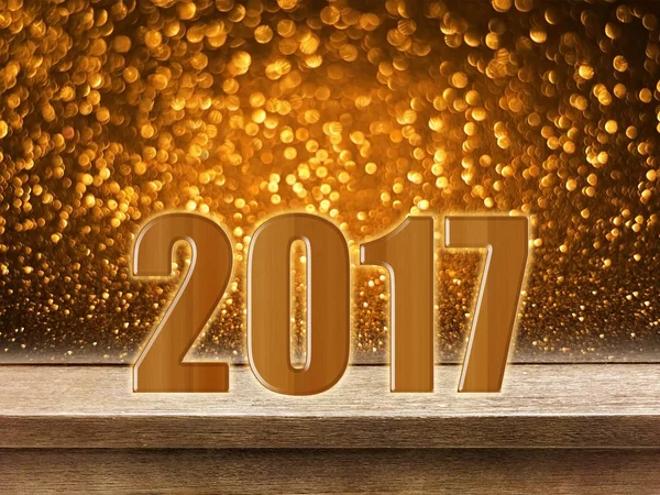 Ευτυχισμένο το νέο έτος 2017 σε ξύλινο τραπέζι με χρυσό glitter bokeh πίσω — Φωτογραφία Αρχείου