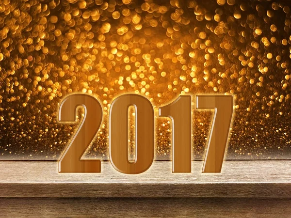 Gelukkig Nieuwjaar 2017 op houten tafel met gouden glitter bokeh terug — Stockfoto