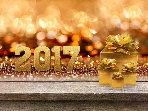 Gold-Geschenkbox und Band mit Wort 2017 auf Holztisch, Bokeh Bac — Stockfoto