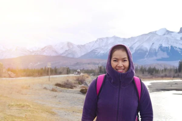 Hiker portrait, female hiking woman happy and smiling in front o