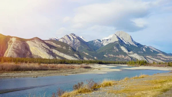 Lake and mountain snow on top with sun ray effect background — Stock Photo, Image