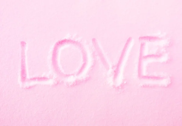 Palabra "AMOR" en la fresca nieve rosa — Foto de Stock