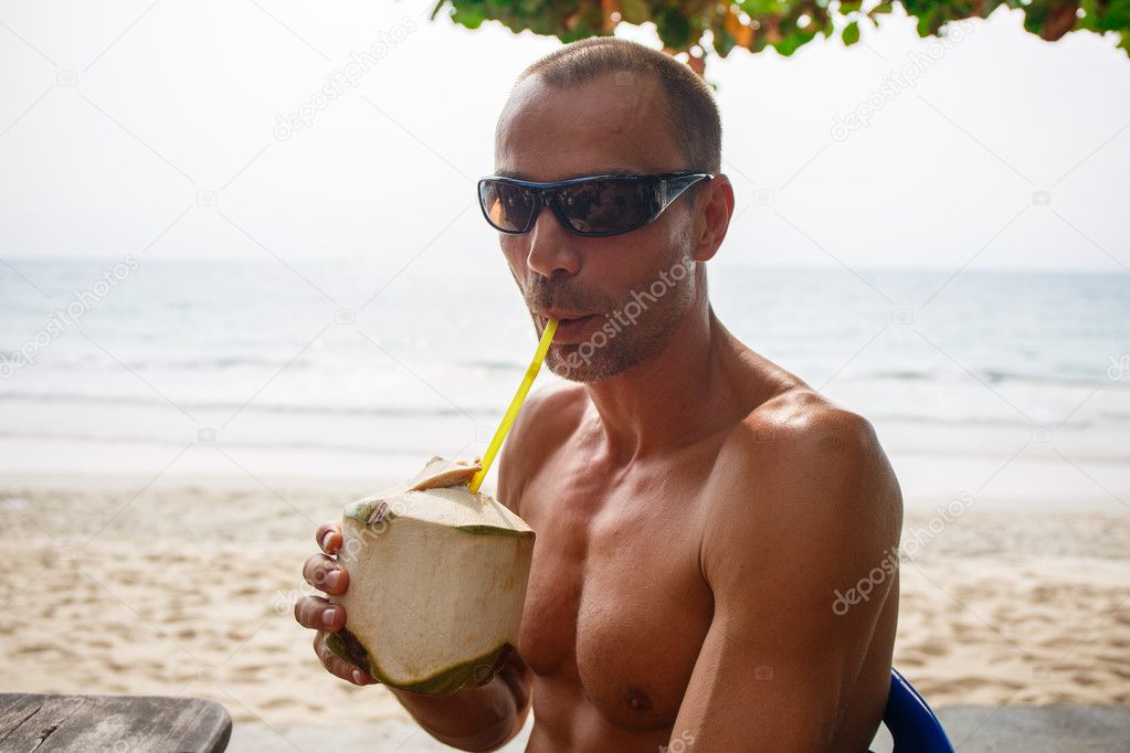 Man drinking coconut