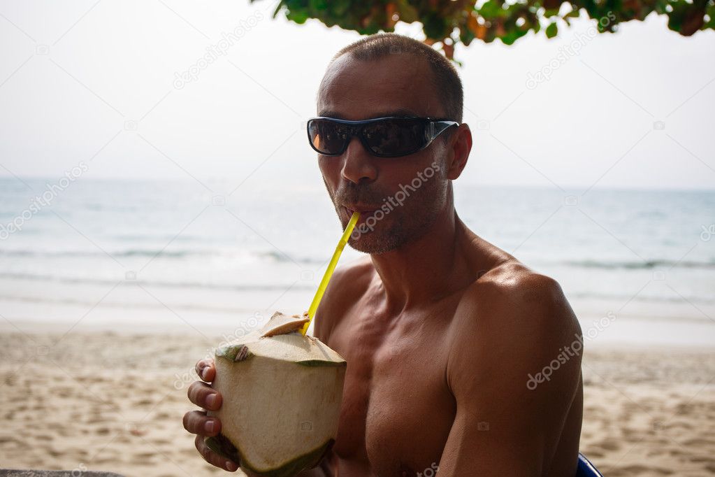 Man drinking coconut