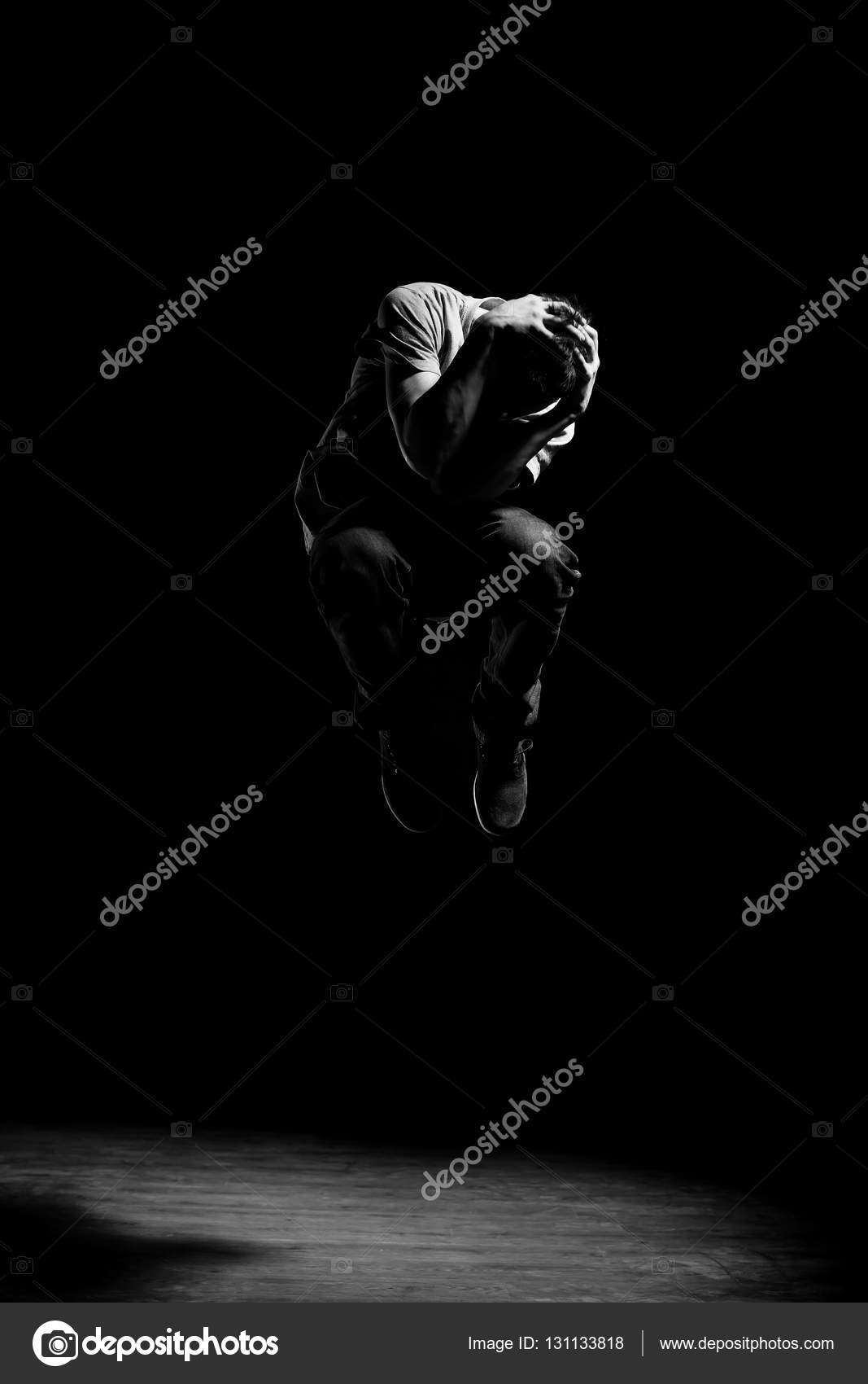 Man in motion on black background studio shot photo by
