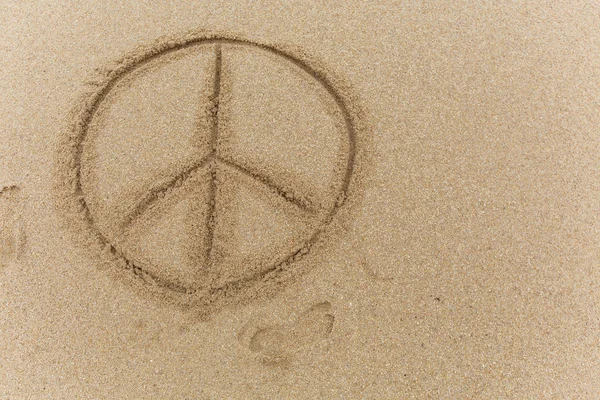 Peace sign on the sand