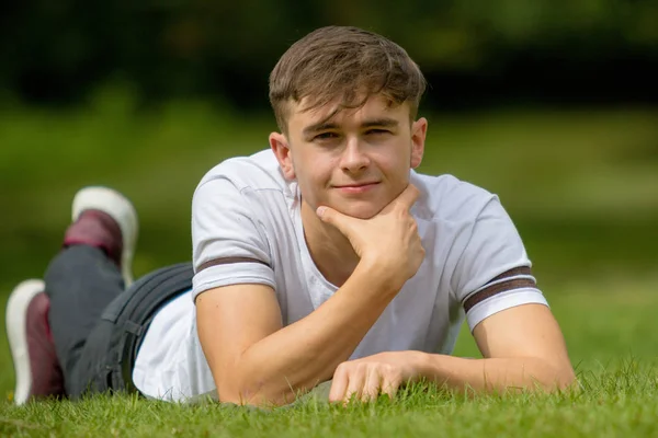 Teenager liegt an einem Sommertag auf Gras — Stockfoto