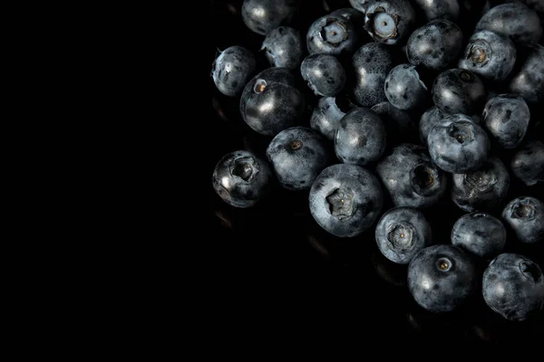 Una pila de arándanos aislados sobre fondo negro —  Fotos de Stock