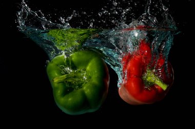 Green & Red Bell Sweet Peppers Droped Into Water clipart