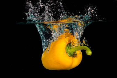 Yellow Bell Sweet Pepper Droped Into Water clipart