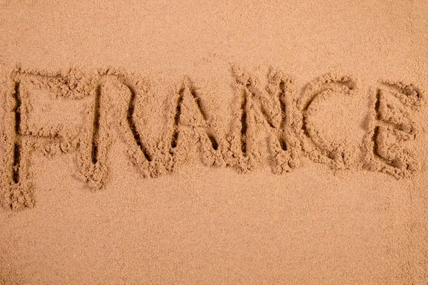 Frankrike på mjuk våt sand på en strand — Stockfoto