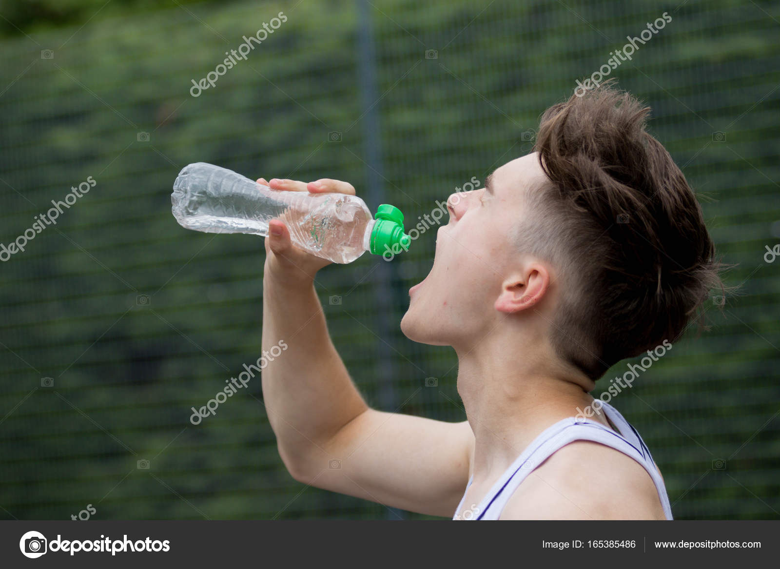 Teenage boy squirting water into his mouth Stock Photo by ©Triumph0828  165385486