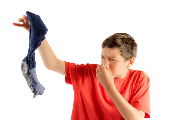 Young teenage boy isolated on a white background holding a smell sock — Stock Photo, Image