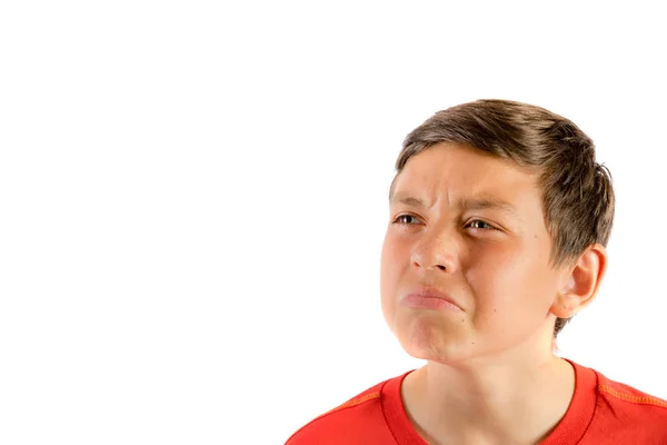 Young teenage boy isolated on a white background wrinkling his nose — Stock Photo, Image