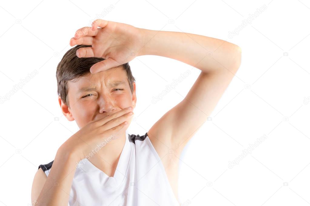 Young teenage boy isolated on a white background with smelly armpit