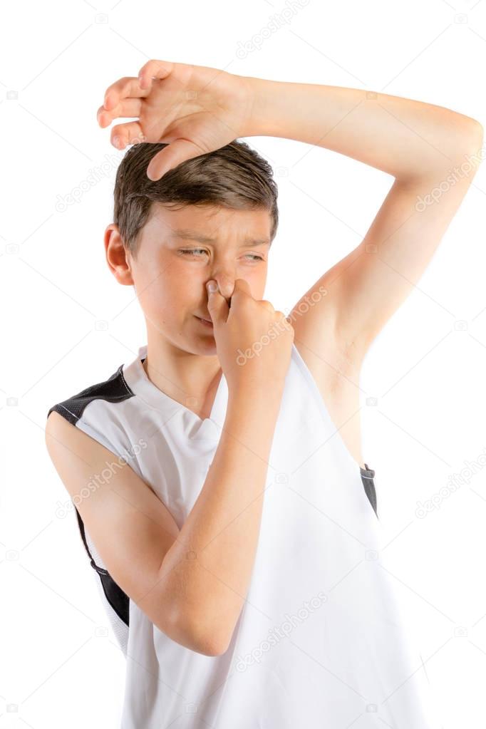 Young teenage boy isolated on a white background with smelly armpit