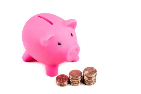 Piggy bank with pile of coins — Stock Photo, Image