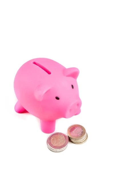 Piggy bank with pile of coins — Stock Photo, Image