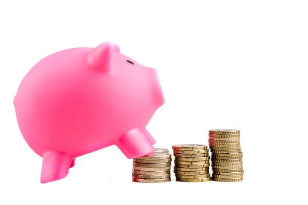 Piggy bank with pile of coins — Stock Photo, Image