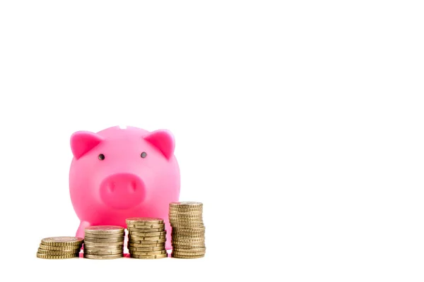 Piggy bank with pile of coins — Stock Photo, Image