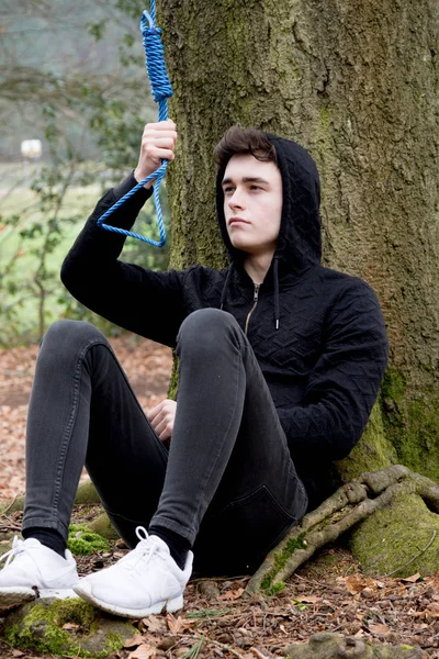 Depressed teenage boy with a hangman's noose — Stock Photo, Image