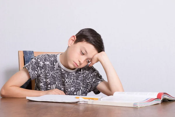 Young teenage boy doing his homework — Stock Photo, Image