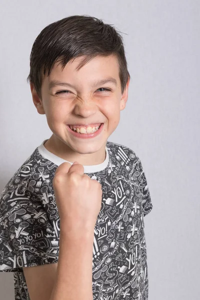 Portait of a boy making a celebration gesture — Stock Photo, Image