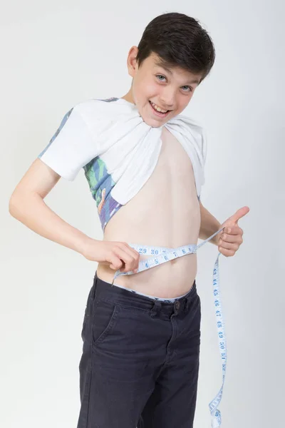 Garçon mesurant sa taille de l'estomac — Photo