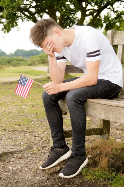 Depressed teenage boy with United States Flag — Stock Photo, Image