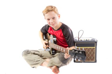 Pre-teen boy and an electric guitar clipart
