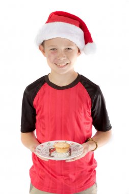 Pre-teen boy and a mince pie clipart