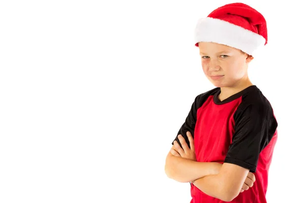 Menino pré-adolescente usando um chapéu de Pai Natal — Fotografia de Stock