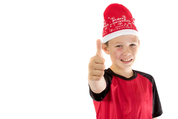 Menino pré-adolescente usando um chapéu de Pai Natal — Fotografia de Stock