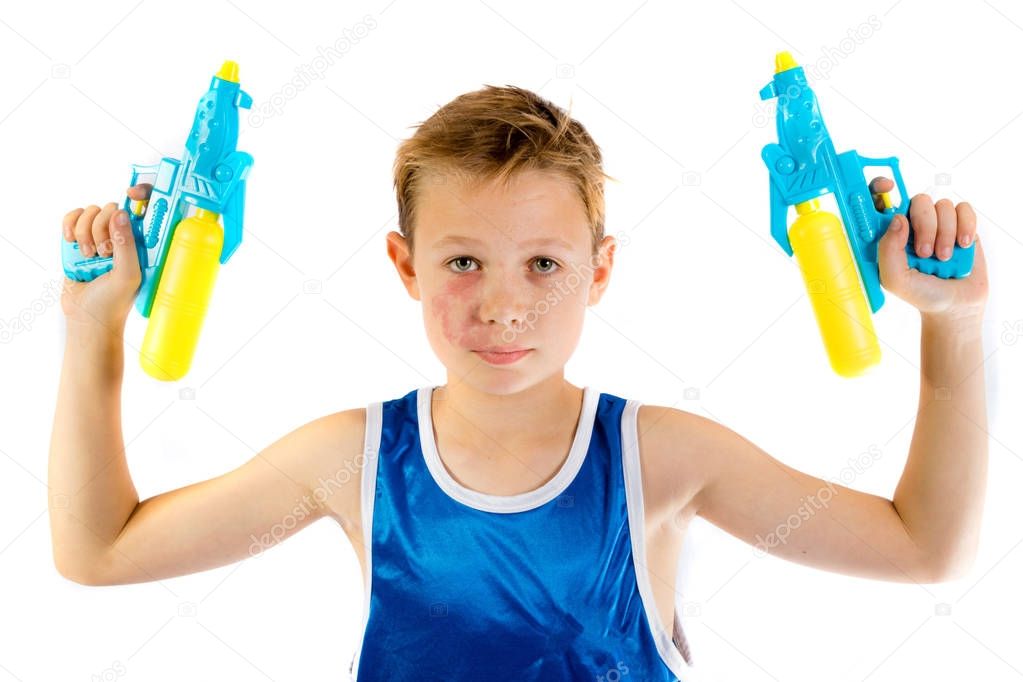 Pre-teen boy playing with water guns