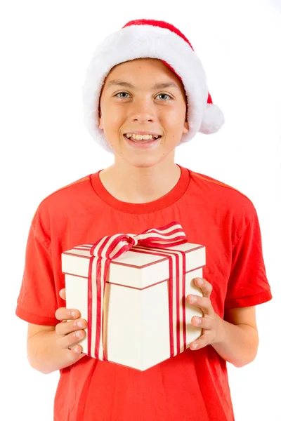 Young teenage boy wearing a Santa Christmas hat with a gift — Stock Photo, Image