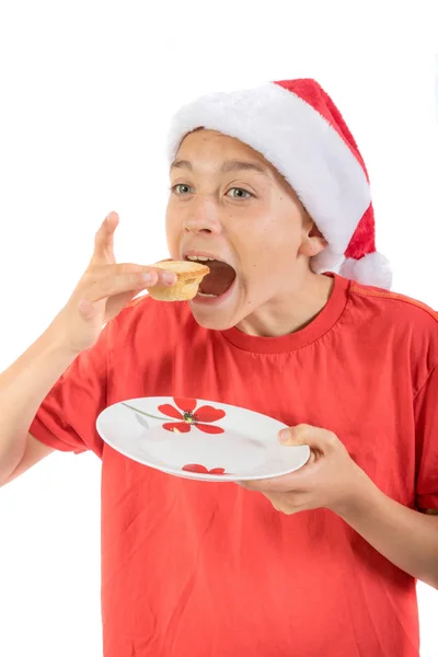 Tizenéves fiú elszigetelt fehér háttér, a finomkodik pite — Stock Fotó