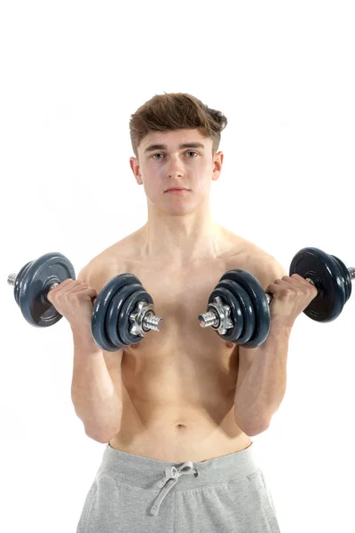 18 Year old teenage boy lifting weights — Stock Photo, Image