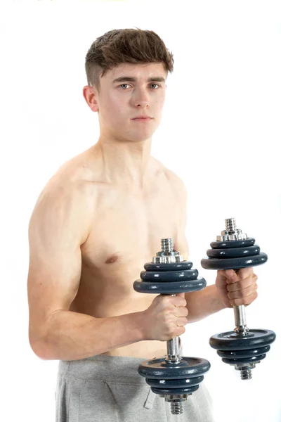18 Year old teenage boy lifting weights — Stock Photo, Image